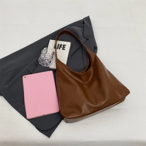 Detail of dark brown faux leather tote with vertical stitching and large capacity