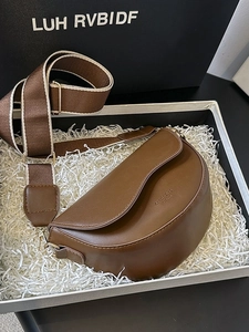 Vintage dark brown saddle bag with wide strap in an elegant gift box presentation