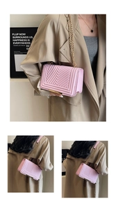 Detail view of pink quilted chain bag with gold metal frame and V-shaped stitching
