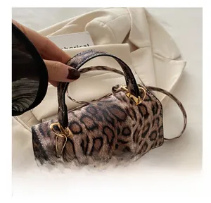 Close-up of leopard print PU leather texture with gold metal buckles and stylish handles