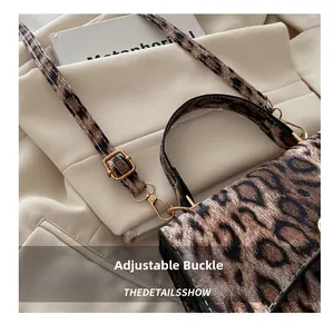 Close-up of adjustable golden buckle and leopard print texture on a chic crossbody bag