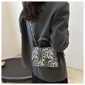 Detailed view of grey leopard print handbag with gold buckle and stylish shoulder strap