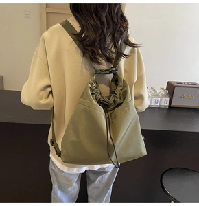 Detail van de legergroene nylon tas met trekkoordsluiting en verstelbare gesp