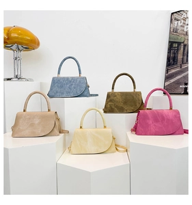 Wildleder Handtaschen in fünf Farben auf weißen Blöcken mit eleganter Dekoration