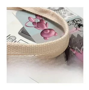 Macro shot of the durable cream canvas tote bag strap featuring premium woven texture