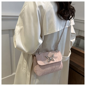 Detail of pink marble pattern crossbody bag with silver butterfly clasp and chain strap