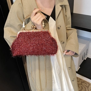 Sparkly red glitter shell handbag with golden metal handle and crossbody chain strap