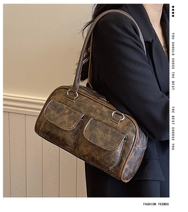 Detail of vintage brown tote bag with crackle texture and dual front pockets