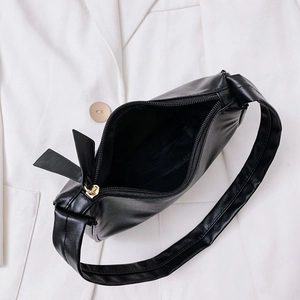 Top view of minimalist black crescent underarm bag showing interior and zip detail