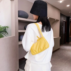 Chic yellow PU underarm shoulder bag paired with minimalist white casual streetwear
