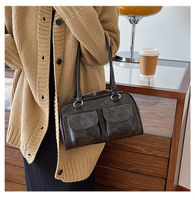Detail of vintage PU leather tote bag with dual front flap pockets and long shoulder straps