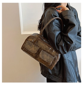 Vintage brown leather shoulder bag with dual front pockets and a distressed retro finish