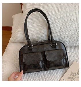 Macro detail of retro dark brown textured faux leather bag with dual front flap pockets