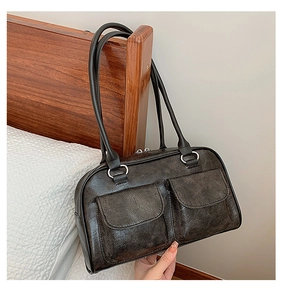 Detail of vintage dark brown tote bag showing textured faux leather and dual front pockets