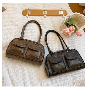 Detail shot of vintage aesthetic faux leather shoulder bags with symmetrical front pockets