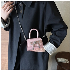Mini pink patent leather crossbody bag with silver rhinestone bow and chain strap
