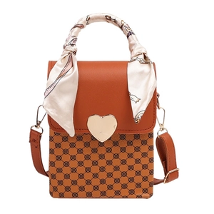 Brown leather crossbody bag with geometric clover pattern and silk scarf handle