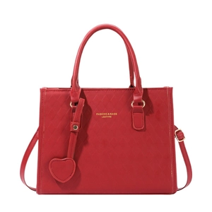 Classic large red leather tote bag with diamond quilted texture and gold lettering