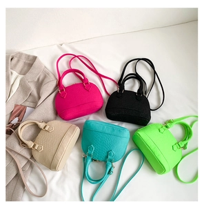 Detailed view of mini shell bags in five colors with faux leather and croc textures