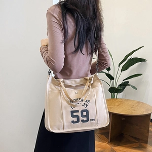 Minimalist beige canvas tote bag with Envisen 59 lettering and adjustable strap