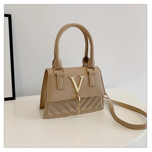 Detail of khaki square bag with gold V-logo fringe and quilted leather pattern