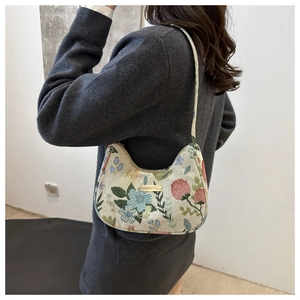 Detail of floral jacquard embroidery on a retro crescent shoulder bag for women