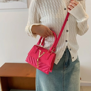 Magenta quilted crossbody flap bag with gold V-logo and fringe tassel for women