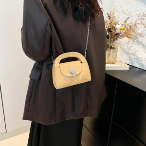 Chic beige crossbody handbag with silver heart buckle and chain strap for women