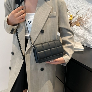 Classic black quilted shoulder bag with silver chain strap shown on model for daily style