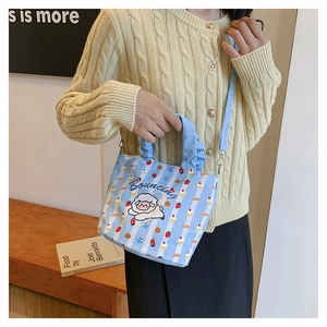 Detail of light blue striped bucket bag with cute cartoon sheep and Bouncing print