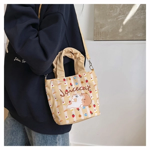 Detail of canvas bucket bag with strawberry cartoon prints and ruched handle