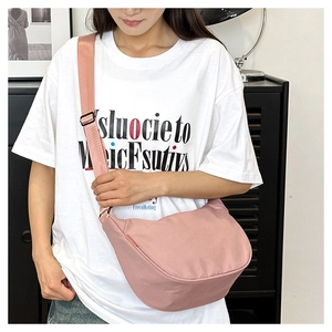 Detail of waterproof nylon crescent bag in dusty pink with adjustable wide strap