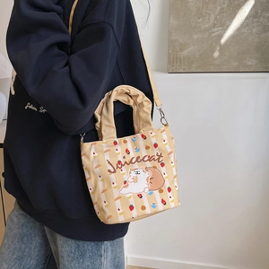 Chic yellow striped canvas bucket bag with cartoon cat print and ruffled handle