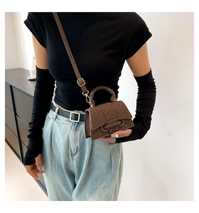 Brown vintage monogram small square handbag shown on model with gold hardware detail