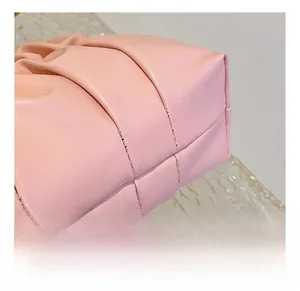 Macro shot of soft pleated pink faux leather with neat stitching on a chain bag