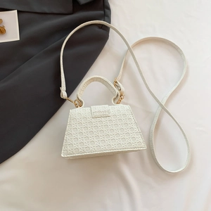 Detailed top view of white trapezoid handbag with cross-weave texture and gold hardware