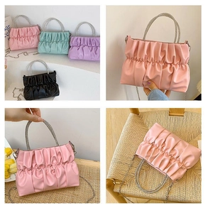 Close-up of pleated cloud bags with crystal handles and chain straps in assorted colors