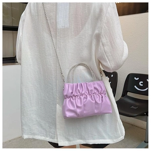 Detail of lavender pleated cloud bag with crystal handle and silver chain strap
