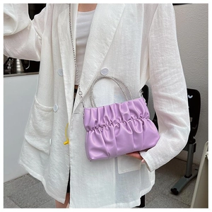 Detail of lavender pleated cloud bag with rhinestone handle and metal chain strap