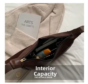 Internal storage view of the brown leather saddle bag filled with daily cosmetics