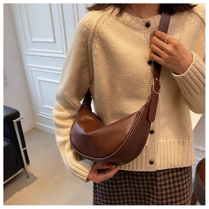 Detailed close-up of brown vintage hobo bag showing matte leather texture and gold metal buckle