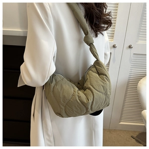 Detail of olive green quilted hobo bag with a soft texture and knot shoulder strap