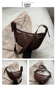 Detail view of coffee brown matte leather saddle bag with adjustable strap and metal buckle