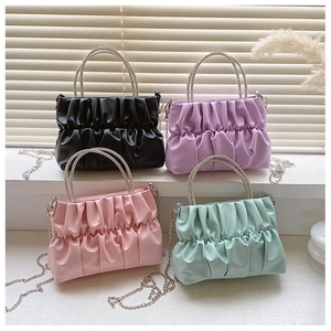 Detail view of ruched purses in black, purple, pink, and green with rhinestone handles