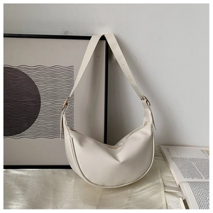 Detail view of a white crescent moon shoulder bag with smooth PU leather and top zipper