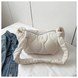 Close-up of off-white quilted puffer hobo bag with soft cloud texture and matching strap