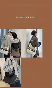 Detailed view of large canvas tote bags in white and grey with MOOD lettering print