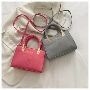 Detail showing faux crocodile pattern textures on magenta and grey fashion handbags