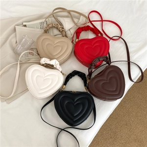 Quilted heart-shaped crossbody bags in beige, red, white, brown and black leather
