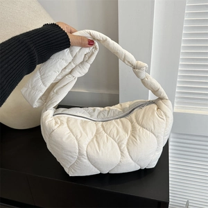 Chic creamy white quilted cloud shoulder bag with stylish knotted strap detail